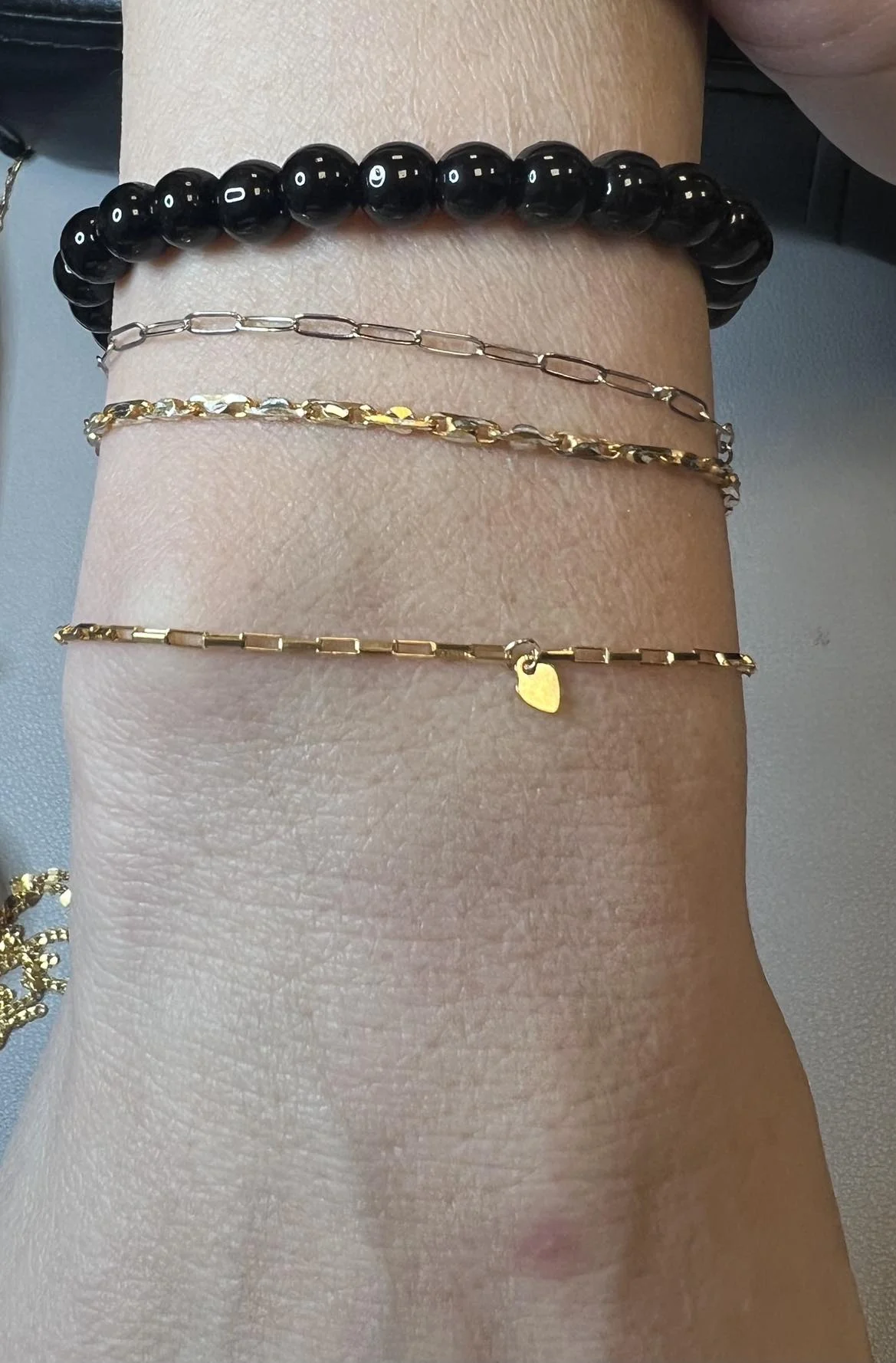 Delicate gold bracelets with a heart detail