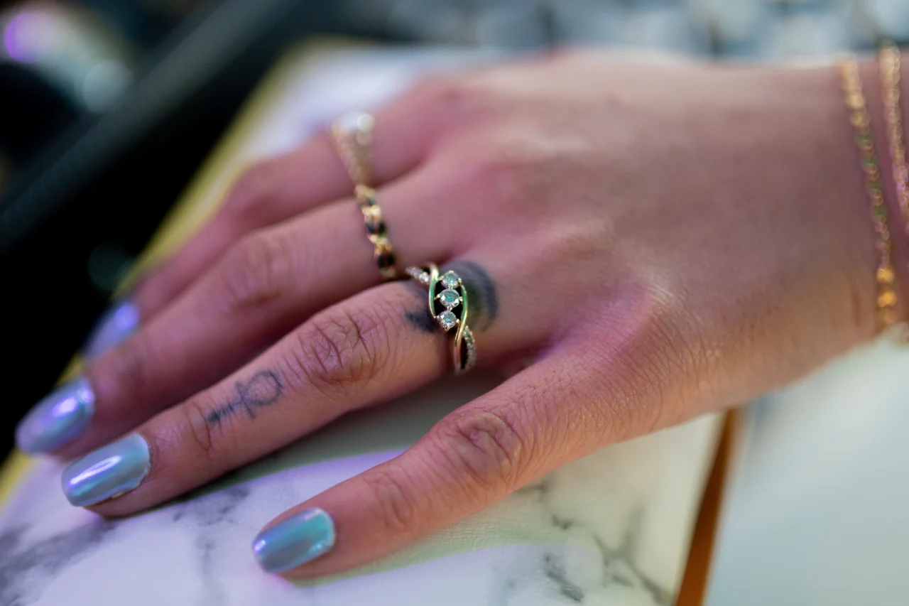 A delicate custom-fit gold ring with personal jewelry details